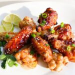 Asian Chili Lime Wings - Crispy oven baked wings covered in a delicious savoury, spicy and tart chili lime sauce!
