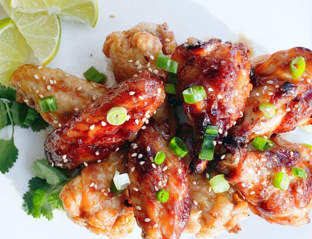 Asian Chili Lime Wings - super addictive crispy and saucy chicken wings that are oven baked!