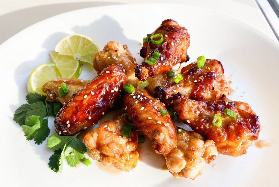 Asian Chili Lime Wings - Crispy oven baked wings covered in a delicious savoury, spicy and tart chili lime sauce!