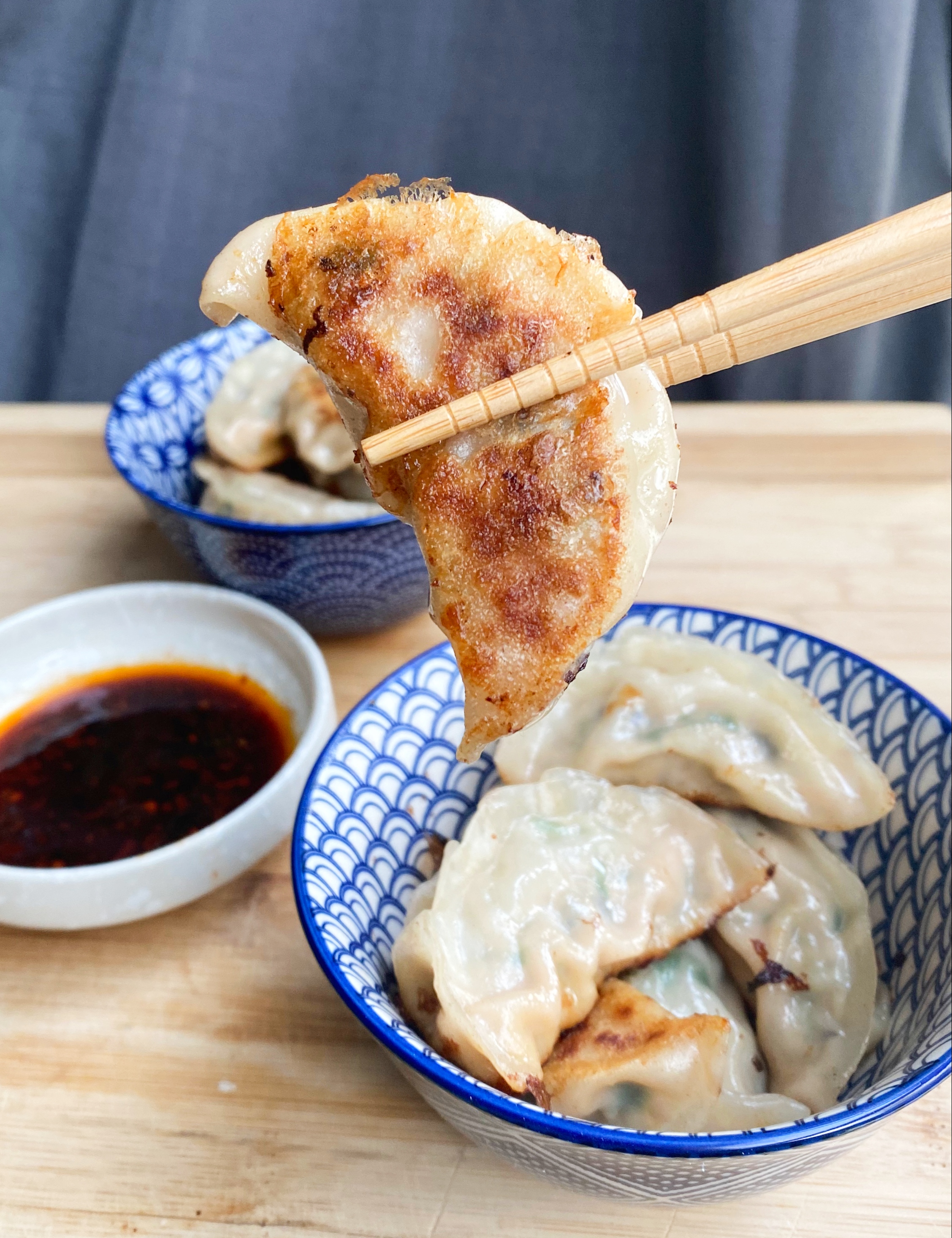 Pork, Shrimp and Chive Dumplings - cooked perfectly with a crispy bottom! Enjoy with a delicious chili soy sauce dipping sauce!