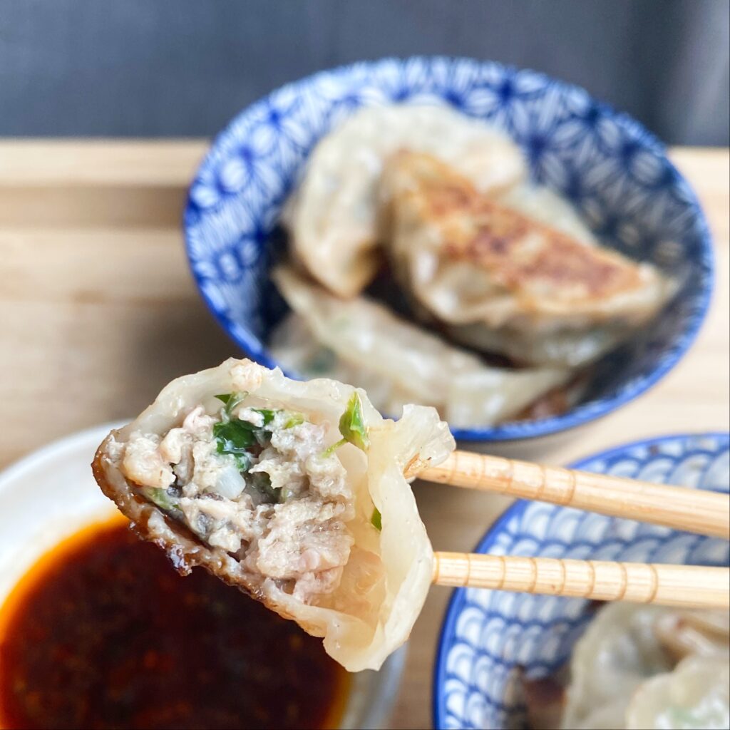 Pork, Shrimp and Chive Dumplings - the perfect bite! Thin crispy skin, juicy filling and a hint of chili sauce!